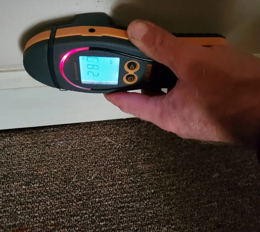 Moisture detection at baseboard during Storm Damage Restoration in Ives Estates